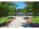 Stunning view of the house from the driveway, surrounded by meticulously maintained grounds and lush landscaping at 201 Edwards Brook Ct, Canton, GA 30115