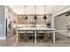 Bright kitchen features a large center island with seating, stainless appliances, and decorative pendant lighting at 201 Edwards Brook Ct, Canton, GA 30115
