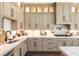 Well-equipped kitchen showcasing stone countertops, cabinetry with modern hardware, and tiled backsplash at 201 Edwards Brook Ct, Canton, GA 30115