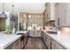 A modern kitchen boasts stylish light wood cabinetry, stainless steel appliances and a sleek black farmhouse sink at 201 Edwards Brook Ct, Canton, GA 30115