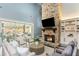Inviting living room with a stone fireplace, comfortable seating, and sliding glass doors to the outdoors at 201 Edwards Brook Ct, Canton, GA 30115