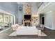 Spacious living room features a stone fireplace, soaring ceilings, and backyard views through sliding glass doors at 201 Edwards Brook Ct, Canton, GA 30115