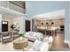 An open living room flows into a modern kitchen with a center island and stainless steel appliances at 201 Edwards Brook Ct, Canton, GA 30115