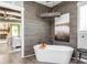 Freestanding tub and wood accent wall is the highlight of the main bathroom with access to main bedroom at 201 Edwards Brook Ct, Canton, GA 30115