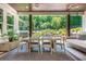 Covered patio with dining area, outdoor kitchen, and relaxing swing overlooking the pool at 201 Edwards Brook Ct, Canton, GA 30115