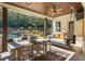 Entertaining outdoor space featuring a dining area and swing sofa with a view of the pool at 201 Edwards Brook Ct, Canton, GA 30115