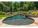 Lush backyard offering a serene pool, spa, and rock waterfall feature for a peaceful outdoor experience at 201 Edwards Brook Ct, Canton, GA 30115