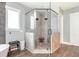 Walk in shower with stone surround, glass door, pebble floor, and dual shower heads at 201 Edwards Brook Ct, Canton, GA 30115