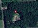 Aerial view of the property nestled among lush trees, creating a private and secluded setting at 3550 Gravitt Rd, Cumming, GA 30040