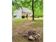 Spacious backyard with mature trees and firepit, perfect for entertaining at 3550 Gravitt Rd, Cumming, GA 30040