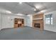 Finished basement featuring cozy fireplace, carpeted floors, and abundant storage space at 3550 Gravitt Rd, Cumming, GA 30040