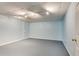 Spacious basement area with neutral carpet, light blue walls, and overhead lighting at 3550 Gravitt Rd, Cumming, GA 30040