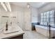 Bathroom features a soaking tub, a double sink vanity, and modern fixtures at 3550 Gravitt Rd, Cumming, GA 30040