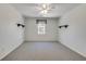 Spacious bedroom with neutral carpet, ceiling fan, and a window with a valance at 3550 Gravitt Rd, Cumming, GA 30040
