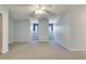 Bright and airy bedroom boasting neutral tones, plush carpeting, and modern ceiling fan at 3550 Gravitt Rd, Cumming, GA 30040