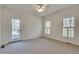 Spacious bedroom with plush carpeting, neutral walls, and a glass panel door to the outside at 3550 Gravitt Rd, Cumming, GA 30040
