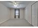 Bedroom with neutral carpet, ceiling fan, and double-door closet at 3550 Gravitt Rd, Cumming, GA 30040