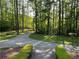Private driveway leading to a home surrounded by lush trees and manicured landscaping at 3550 Gravitt Rd, Cumming, GA 30040