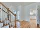 Welcoming entryway with hardwood floors and an open view to the kitchen at 3550 Gravitt Rd, Cumming, GA 30040