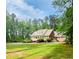 Beautiful two-story brick house with well-manicured lawn and mature trees at 3550 Gravitt Rd, Cumming, GA 30040