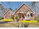 Charming brick home featuring a well-manicured lawn and private entrances with lush green surroundings at 3550 Gravitt Rd, Cumming, GA 30040
