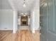 Inviting foyer with hardwood floors and a view of the living room with a stone fireplace at 3550 Gravitt Rd, Cumming, GA 30040