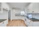 Well-maintained kitchen featuring white cabinets, hardwood floors, and modern appliances at 3550 Gravitt Rd, Cumming, GA 30040