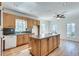 Spacious kitchen features an island, wooden cabinets and hardwood floors at 3550 Gravitt Rd, Cumming, GA 30040