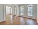 Spacious living room with hardwood floors, arched doorways, and large windows that fill the room with light at 3550 Gravitt Rd, Cumming, GA 30040