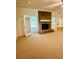 Spacious living room with a stone fireplace, a door to the outside, and natural light at 3550 Gravitt Rd, Cumming, GA 30040