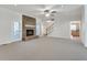 Cozy living room features stone fireplace, neutral carpet and access to rear exterior at 3550 Gravitt Rd, Cumming, GA 30040