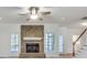 Living room features a stone fireplace, white trim, and lots of natural light at 3550 Gravitt Rd, Cumming, GA 30040