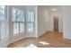 Bright living room with hardwood floors, white walls, and bay windows with plantation shutters at 3550 Gravitt Rd, Cumming, GA 30040