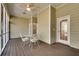 Charming screened-in patio with a ceiling fan, perfect for outdoor dining and enjoying the surrounding nature at 3550 Gravitt Rd, Cumming, GA 30040