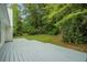 A well-maintained back deck with a view of the lush and well-maintained backyard creates a relaxing retreat at 5936 Old Wellborn Trce, Lithonia, GA 30058