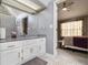 Bathroom vanity with gray countertops, white cabinetry, and tile floors is bright and clean at 5936 Old Wellborn Trce, Lithonia, GA 30058