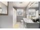 Well-lit bathroom featuring a stylish vanity with marble countertop and decorative backsplash at 5936 Old Wellborn Trce, Lithonia, GA 30058