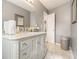 Neutral bathroom with an elegant vanity, marble countertop, and framed mirror at 5936 Old Wellborn Trce, Lithonia, GA 30058