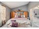 Spacious main bedroom features vaulted ceiling, a large bed, and ensuite access at 5936 Old Wellborn Trce, Lithonia, GA 30058
