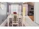 A dining room with a view offering a large window, modern furniture and decor provides a relaxing area at 5936 Old Wellborn Trce, Lithonia, GA 30058