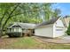Charming single-story home with a well-manicured lawn, a brick facade, and an attached two-car garage at 5936 Old Wellborn Trce, Lithonia, GA 30058