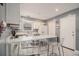 Bright kitchen featuring marble countertops, stainless steel appliances, and an open island seating area at 5936 Old Wellborn Trce, Lithonia, GA 30058
