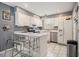 Bright kitchen featuring white cabinetry, stainless steel appliances, and an island with counter seating at 5936 Old Wellborn Trce, Lithonia, GA 30058