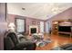 Charming living room with hardwood floors, a fireplace, and comfortable gray seating invites relaxation at 5936 Old Wellborn Trce, Lithonia, GA 30058