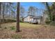 View of a private backyard with a deck, fence, and mature trees, offering a serene outdoor space at 3807 Memorial Nw Pkwy, Kennesaw, GA 30152