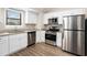 Modern kitchen with stainless steel appliances, white cabinets, and granite countertops at 3807 Memorial Nw Pkwy, Kennesaw, GA 30152