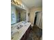 Bathroom featuring double sinks, vanity with cabinets, and tiled floor at 398 Kyles Cir, Hiram, GA 30141