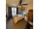This is a brightly lit bedroom featuring a ceiling fan and a comfortable bed at 398 Kyles Cir, Hiram, GA 30141
