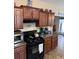 Well-equipped kitchen features dark wood cabinets and modern appliances at 398 Kyles Cir, Hiram, GA 30141