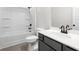 Chic bathroom featuring a combination shower and tub with modern fixtures, a white countertop, and a dark vanity cabinet at 712 Shetland Trl, Cartersville, GA 30121
